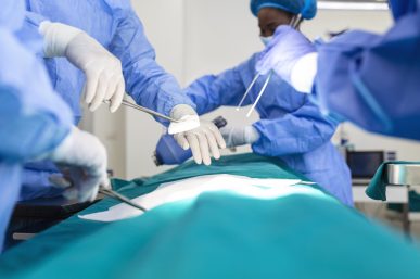 Surgeon team in uniform performs an operation on a patient at a cardiac surgery clinic. Modern medicine, a professional team of surgeons, health.